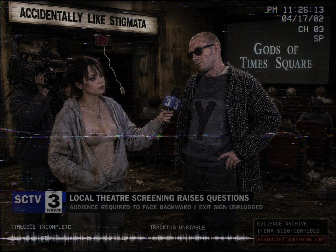 Reconstructed wide local-news frame reporting that the theatre audience faced backward and the exit sign was unplugged